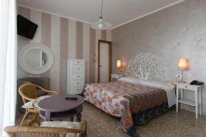 Postel nebo postele na pokoji v ubytování Hotel Mirabello