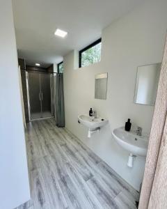 a bathroom with two sinks and a shower at Kemp Pod Lipami in Dolní Bečva