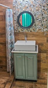 a bathroom with a sink and a mirror at Villa De Cruz - Groovy Suite in Scarborough