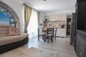 a living room with a couch and a table at Holidays Summer Vibes Apart Mamaia Nord in Năvodari