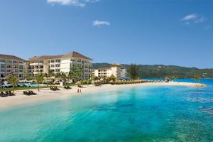 a view of a beach with condos in the background at Secrets Wild Orchid in Montego Bay