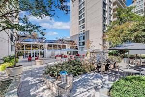 un patio con mesas y sillas y un edificio en Spectacular 2/2 Apt @Crystal City With Gym en Arlington