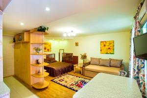 a living room with a couch and a bed at Sun in the City Center in Kherson