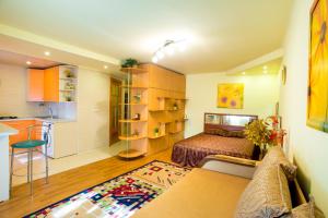 a small room with a bed and a kitchen at Sun in the City Center in Kherson