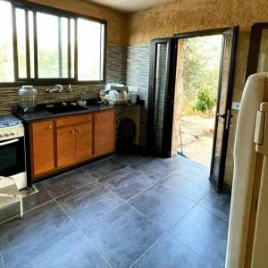 a kitchen with a sink and a stove at Beit el Deif in Jbeil