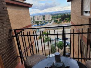 a balcony with a table and a view of a city at Privada Confort Granada in Granada