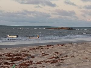 a beach with a boat in the water at Casas Bennu Preá in Prea