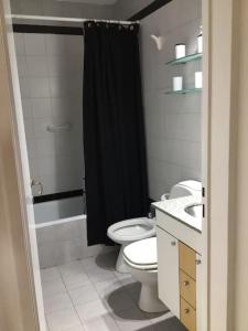 a bathroom with a black shower curtain and a toilet at Departamento en Palermo Parking included in Buenos Aires