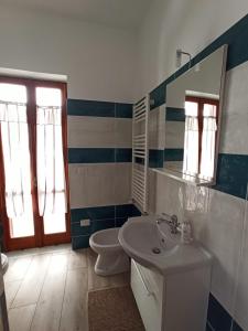 a bathroom with a sink and a toilet and a mirror at B&B In Sella in Vico Equense +20 photos