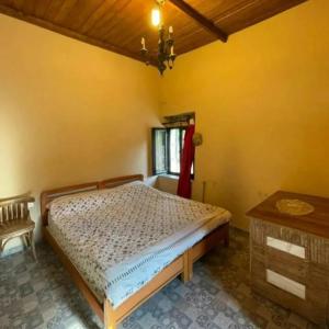 a bedroom with a bed and a table and a window at Beit el Deif in Jbeil