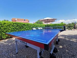 a ping pong table with an umbrella on it at Apartments Lea with pool in Malinska