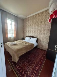 a bedroom with a bed with a teddy bear on the wall at Ideal in Akhaltsikhe