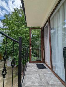 a balcony with a view of a glass door at DATI in Borjomi