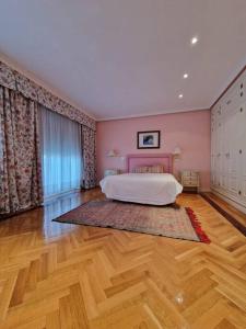 a bedroom with a bed and a wooden floor at La Casona Imperial in Alpedrete +42 photos