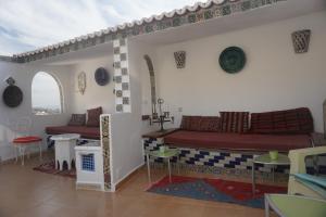 a living room with a couch and a table at Dar Anneke in Chefchaouen