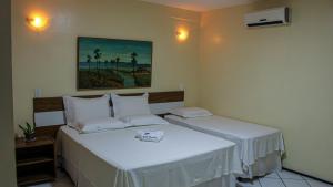 Ένα ή περισσότερα κρεβάτια σε δωμάτιο στο Hotel Monólitos