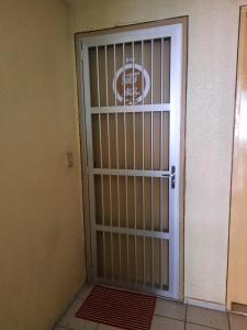 a door with bars on it next to a building at Apartamento por temporada in Fortaleza