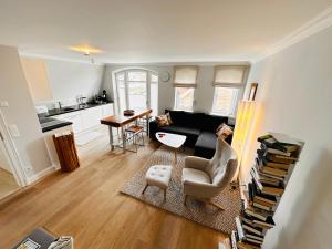 a living room with a couch and a table at Meer-Lust-Sylt Haus Mateika in Westerland