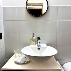 a bathroom with a white sink and a mirror at Entre Rosas y Flores in Guatemala