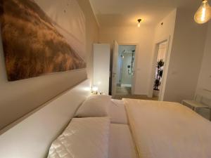 a bedroom with two beds and a painting on the wall at Boutiqueloft Vista in Bardolino +14 photos