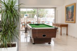 a room with a pool table and some plants at Flora Hotel Apartments in Protaras