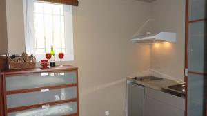a small kitchen with a sink and a window at BASTIDE DIORLEAC in Lorgues
