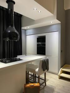 a kitchen with a stove and a white counter top at Portici Design Suite - Historical Center in Bologna