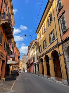 an empty street in a city with buildings at Portici Design Suite - Historical Center in Bologna