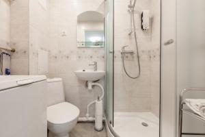 a bathroom with a toilet and a sink and a shower at Bright Apartment near Bus Statioon in Tallinn