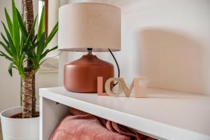 a lamp on a shelf with a love sign at Boutiqueloft Vista in Bardolino