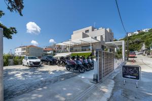 a group of motorcycles parked in a parking lot at Niso Skiathos in Skiathos Town