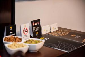 a table with two bowls of food and a box at Grand Plaza Badr Al Maqam in Al Madinah