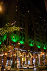 a building with green lights in front of it at Grand Plaza Badr Al Maqam in Al Madinah