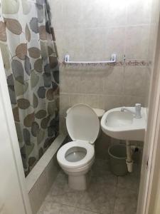 a small bathroom with a toilet and a sink at Hotel Freedom Nagua in Nagua