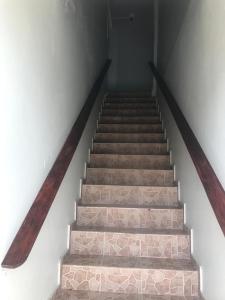 a set of stairs in a room with a stair case at Hotel Freedom Nagua in Nagua