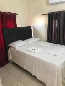 a bedroom with a bed with two trays on it at Hotel Freedom Nagua in Nagua