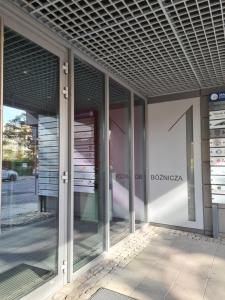 an external view of a building with glass doors at Boznicza Old Town LUX Apartment, self check-in 24h, free parking in Poznań