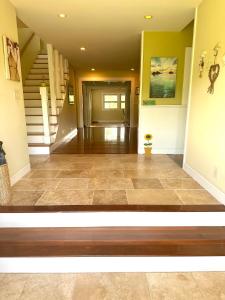 a hallway of a home with a tile floor and stairs at Modern Luxury Beach House Kailua in Kailua