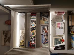 a staircase in a room with books and records at Hotel Lucerna in Castiglione della Pescaia