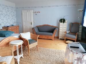 a living room with a bed and chairs and a table at Landtraum im Traumland Mecklenburg in Warin