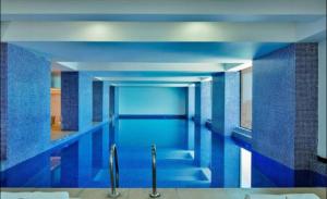 una gran piscina con azulejos azules en las paredes en Apartment with beautiful view, free wifi, swimming pool and gym, en Dar es Salaam