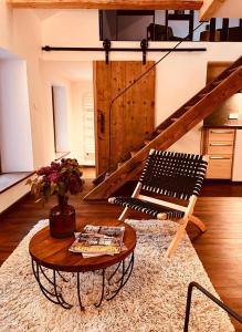 a living room with a bench and a table at Domaine du Pré-Saint-Georges in Taintrux