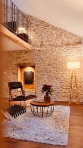 a living room with a coffee table and a brick wall at Domaine du Pré-Saint-Georges in Taintrux