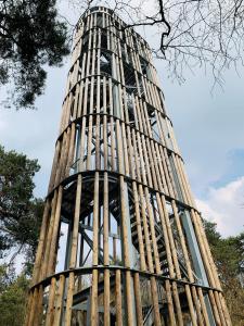 a tall building with a fence around it at Tukken op de Maashorst in Schayk