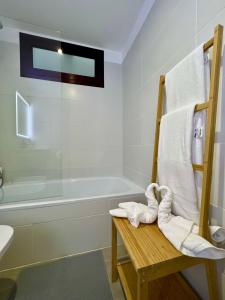 a bathroom with a towel rack and a bath tub at Chalet Adosado El Medano in El Médano