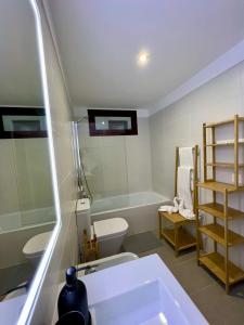 a bathroom with a tub and a toilet and a sink at Chalet Adosado El Medano in El Médano +57 photos