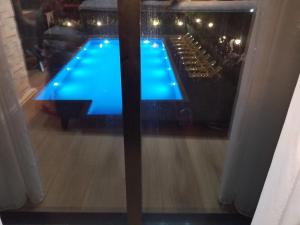 a reflection of a swimming pool in a window at Wave-ტალღა in Kobuleti