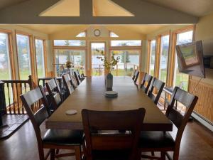 a large dining room with a long table and chairs at Northern Lights from Hot Tub, Denali National Park in McKinley Park