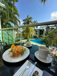 a table with a sandwich and a cup of coffee at Hotel Plaza Caribe in Cancún