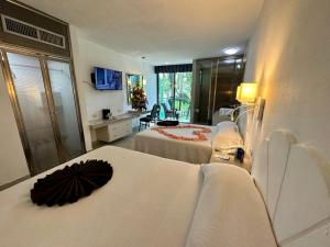 Postel nebo postele na pokoji v ubytování Hotel Plaza Caribe